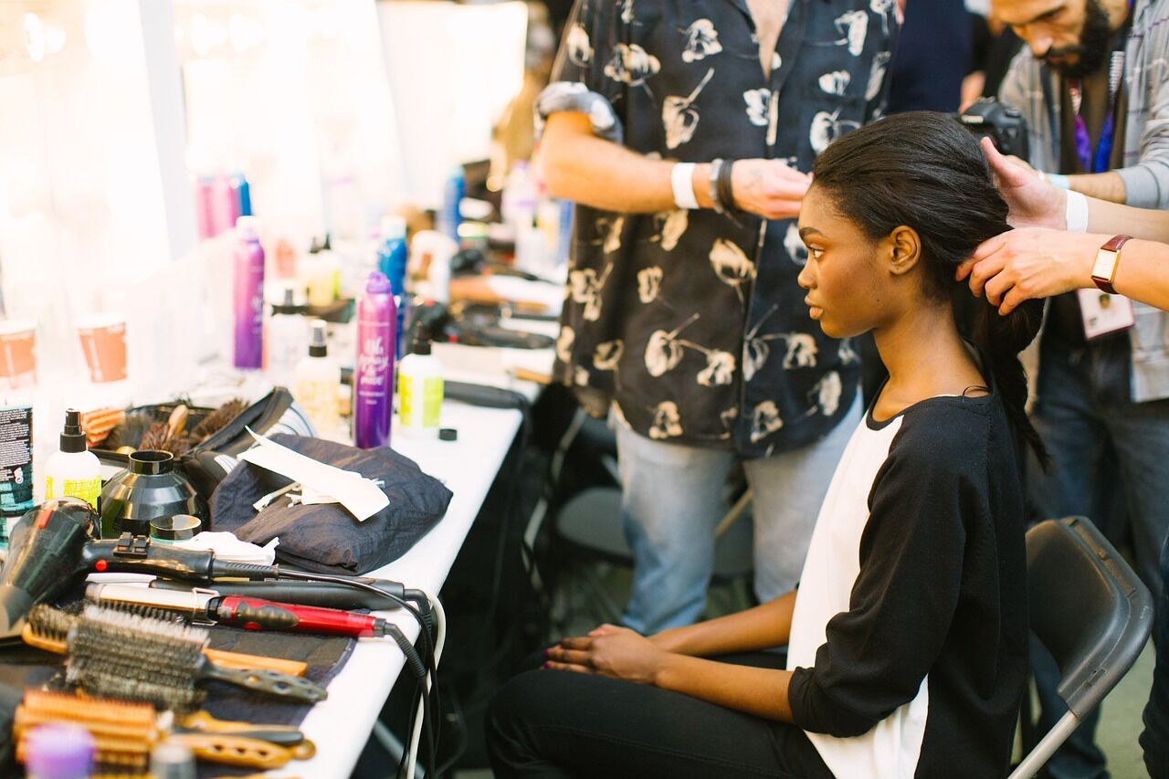 Woman's hair gets cut and done in a beauty salon